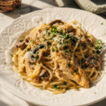 Creamy chicken spaghetti with mushrooms, pepper jack cheese, and imported Italian pasta served in a white bowl.