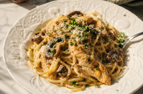 Creamy chicken spaghetti with mushrooms, pepper jack cheese, and imported Italian pasta served in a white bowl.