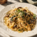 Creamy chicken spaghetti with mushrooms, pepper jack cheese, and imported Italian pasta served in a white bowl.